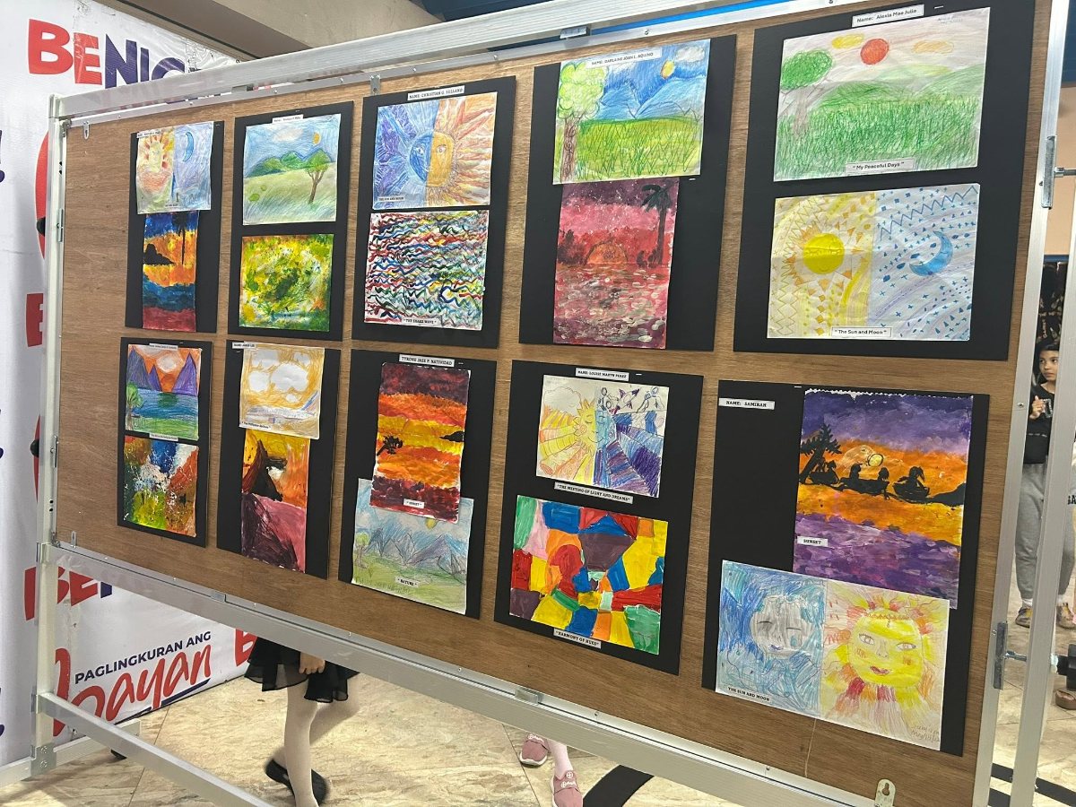 Art table with paints, brushes, and a sketchbook