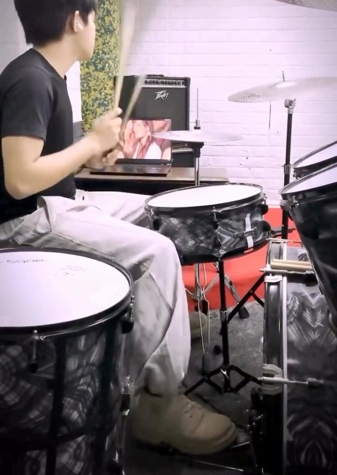 Student behind the drum kit during a lesson